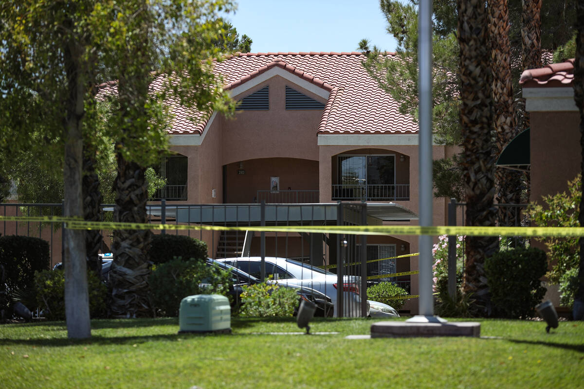 Police at the scene of a homicide at an apartment complex where three people were killed in wes ...