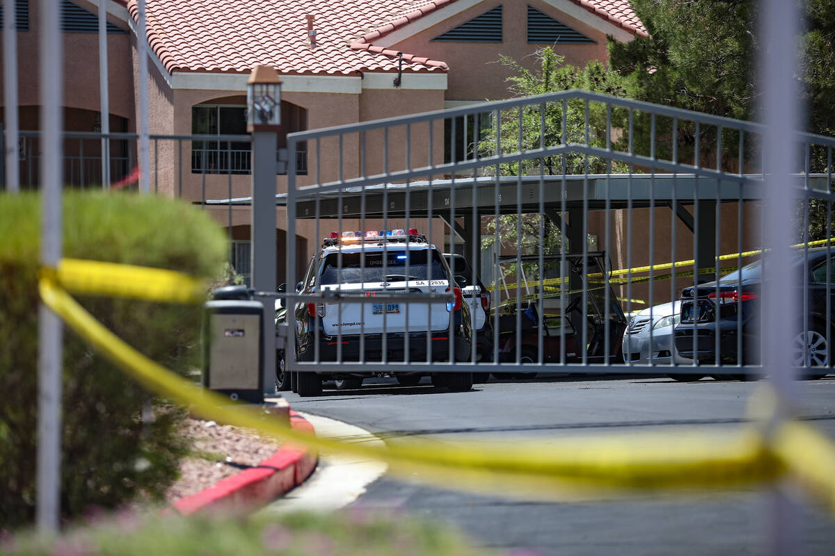 Police at the scene of a homicide at an apartment complex where three people were killed in wes ...