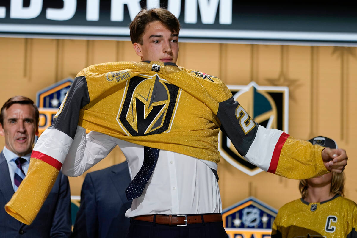 David Edstrom puts on a Las Vegas Golden Knights jersey after being picked by the team during t ...