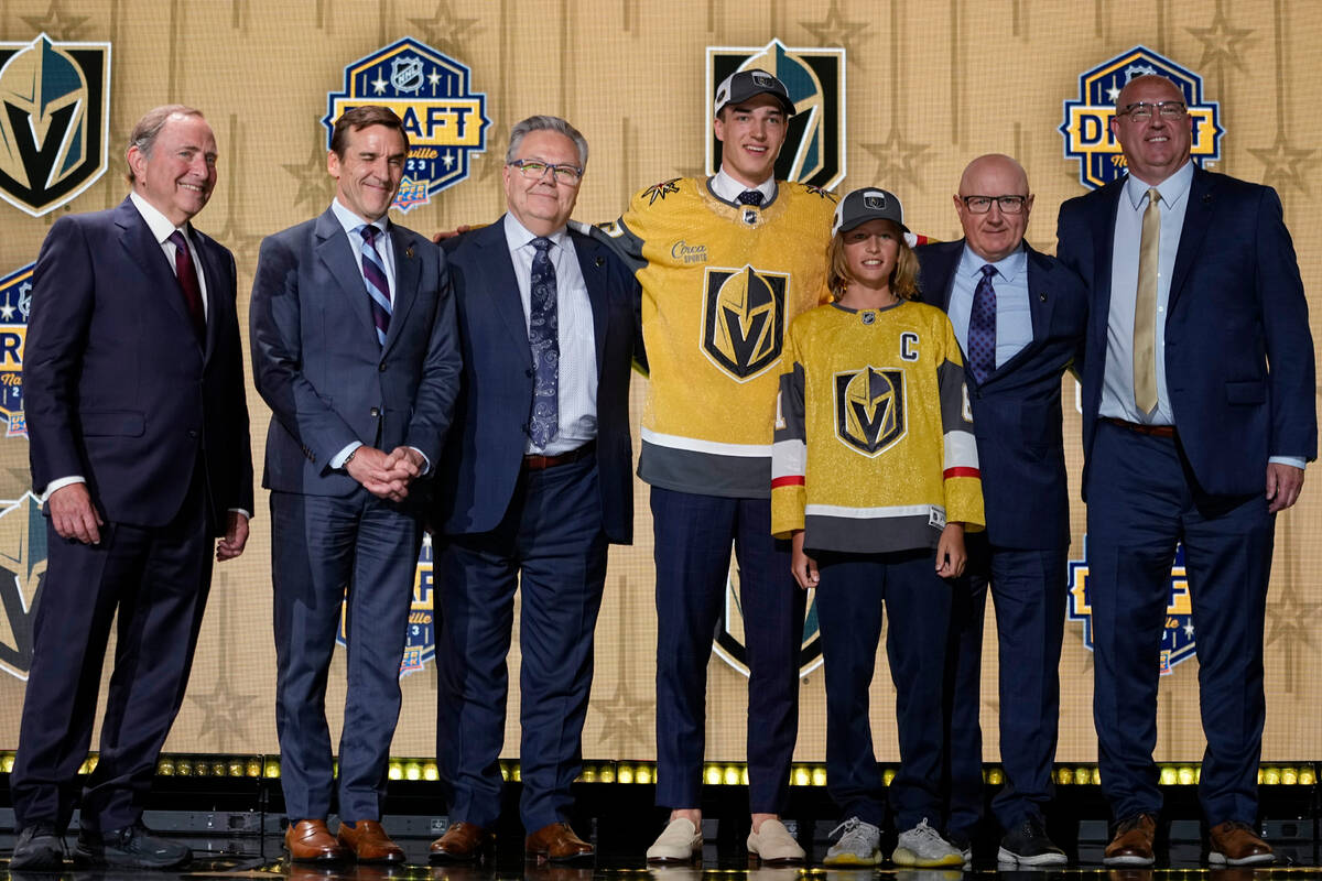 David Edstrom, center, poses with Las Vegas Golden Knights officials after being picked by the ...