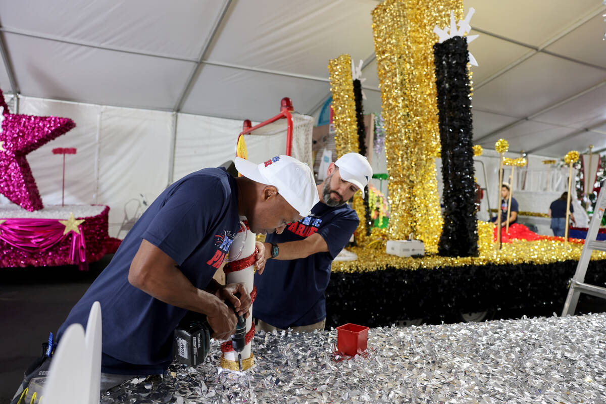 Volunteers Isiah Powell, left, and Dave Bailey work on a float for the 29th annual Summerlin Co ...