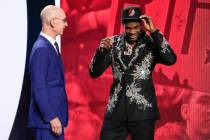 Scoot Henderson, right, dons a Portland Trailblazers hat with NBA Commissioner Adam Silver watc ...