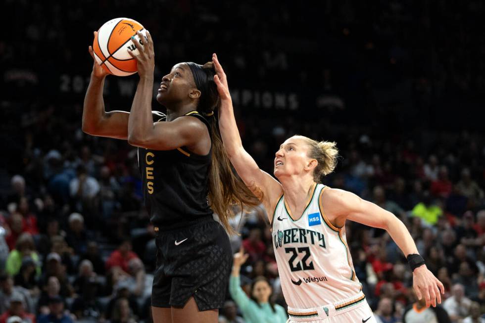 Las Vegas Aces guard Jackie Young (0) shoots against New York Liberty guard Courtney Vandersloo ...