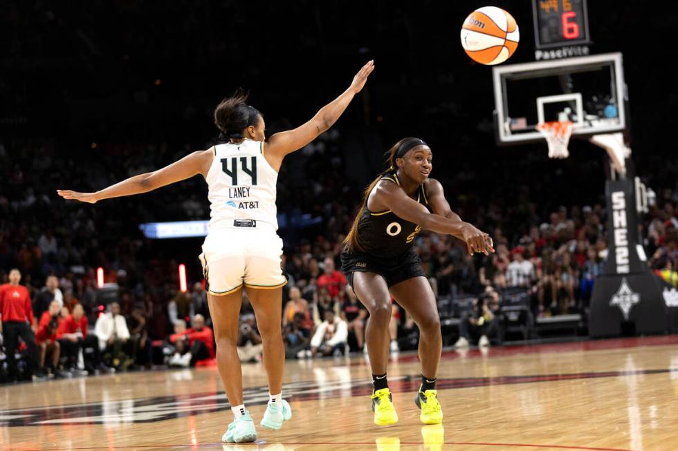 Las Vegas Aces guard Jackie Young (0) passes up the court while New York Liberty forward Betnij ...