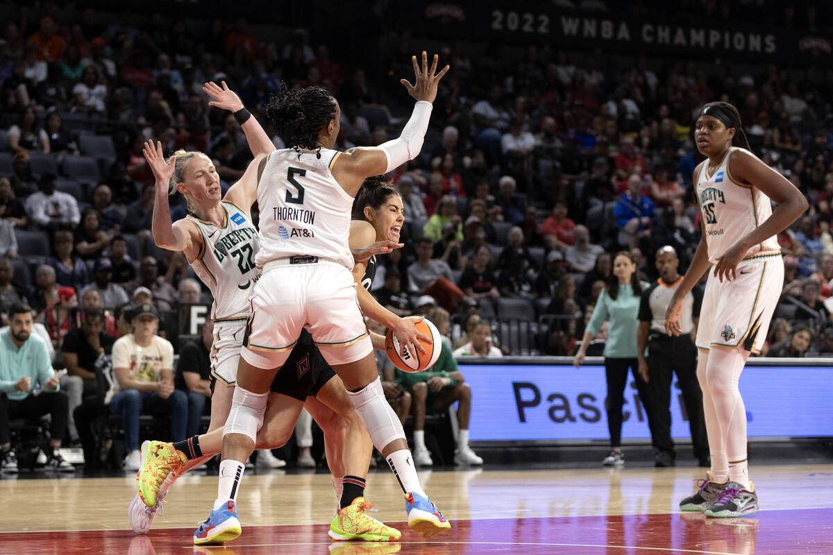 Las Vegas Aces guard Kelsey Plum (10) drives through New York Liberty guard Courtney Vandersloo ...