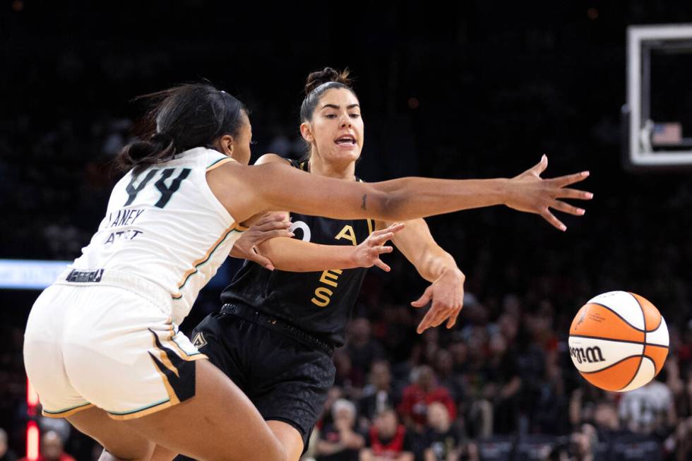 Las Vegas Aces guard Kelsey Plum (10) passes around New York Liberty forward Betnijah Laney (44 ...