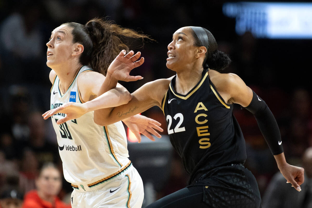 New York Liberty forward Breanna Stewart (30) and Las Vegas Aces forward A'ja Wilson (22) tangl ...