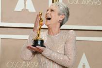 Jamie Lee Curtis poses with the award for best performance by an actress in a supporting role f ...