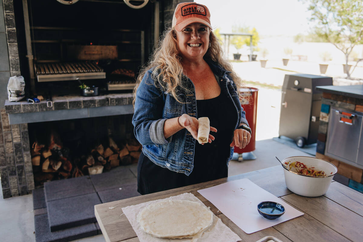 Christie Vanover poses with homemade lumpia Filipino spring rolls on Friday, June 30, 2023, in ...