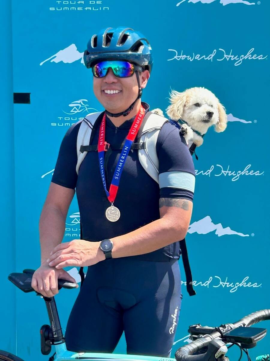 Cyclist Marc Salvador, a Summerlin resident, often cycles around the community with his dog, Wi ...
