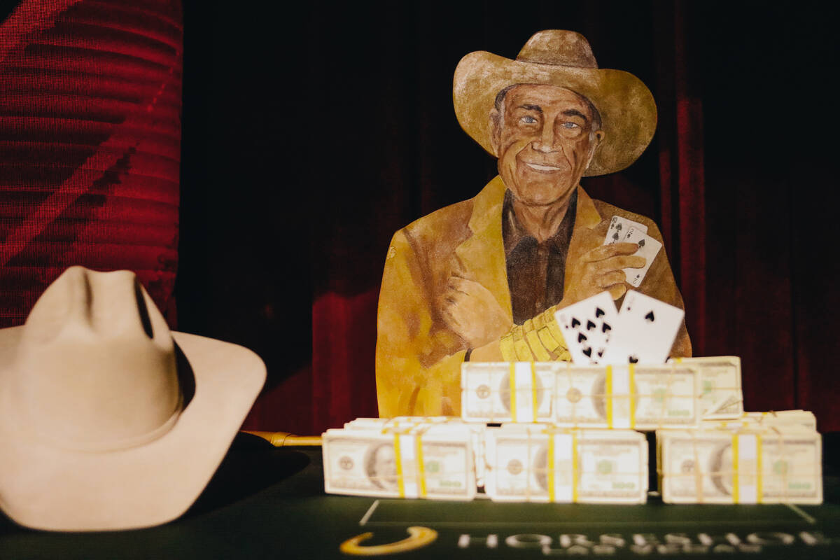 A painting of poker legend Doyle Brunson, along with stacks of money and a cowboy hat worn by B ...