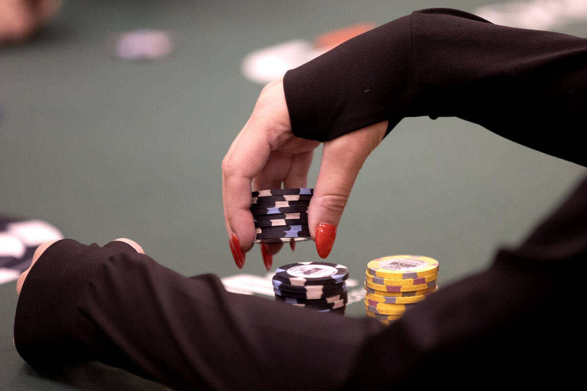 A player antes during the World Series of Poker $10,000 buy-in No-limit Hold’em World Ch ...