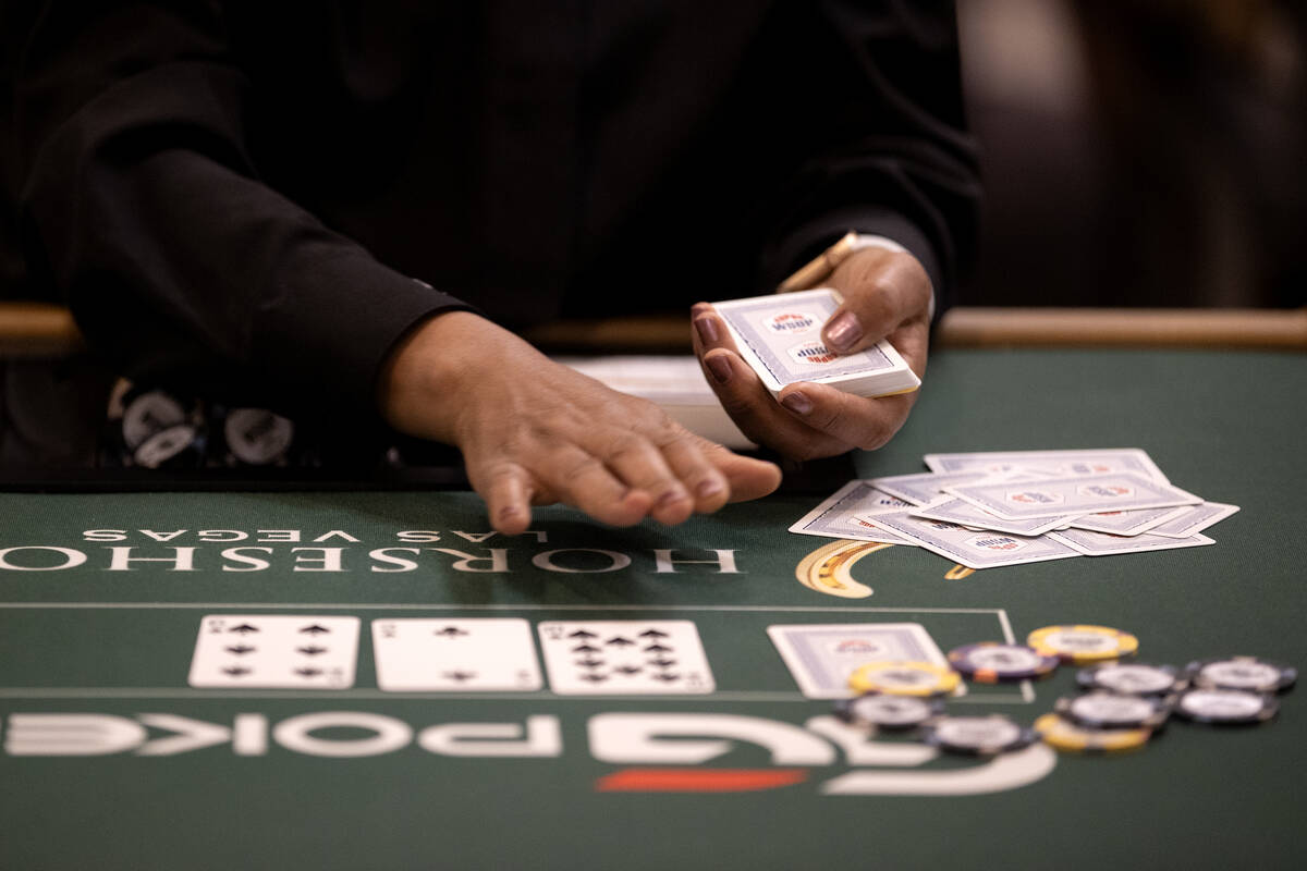 A dealer hands out cards during the World Series of Poker $10,000 buy-in No-limit Hold’e ...