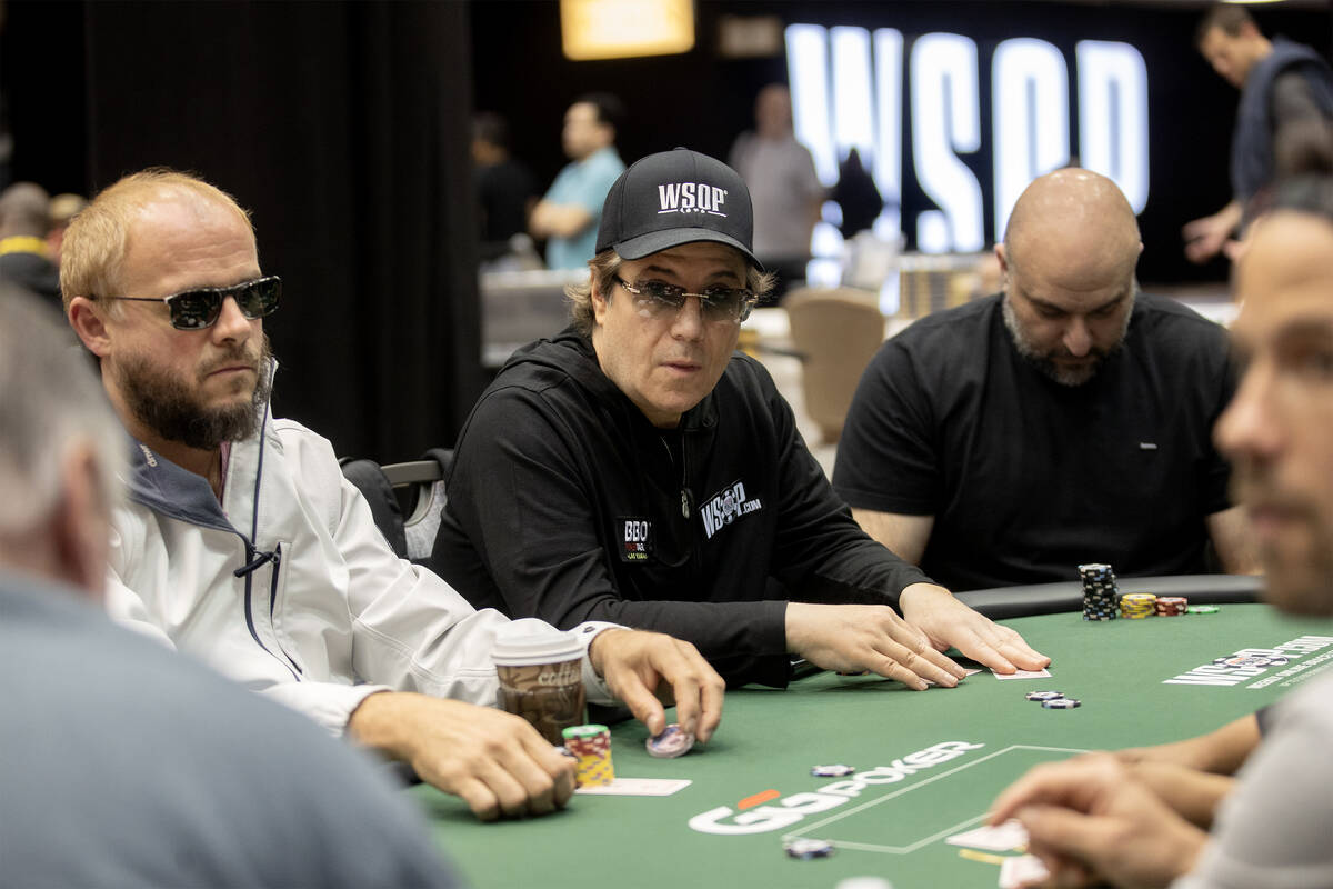 Jamie Gold, center, eyes his opponent during the World Series of Poker $10,000 buy-in No-limit ...