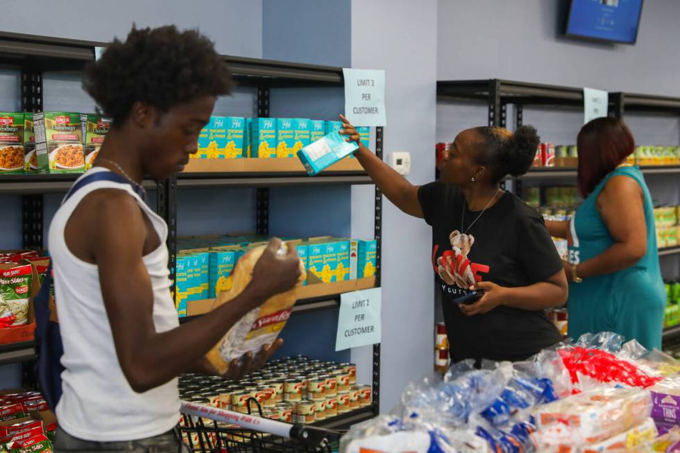 Darius Haney, left, shops for groceries while Tranisha Mckinney, center, and Adrian McCoy resto ...