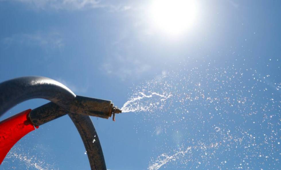 A miniature water park at Bob Baskin Park helps local residents cool down during the 110 degree ...