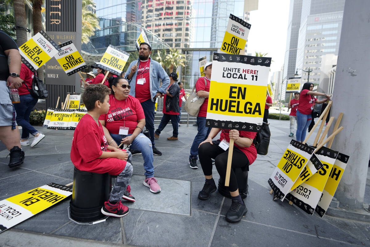 Striking hotel workers rally outside the Intercontinental Hotel after walking off their job ear ...