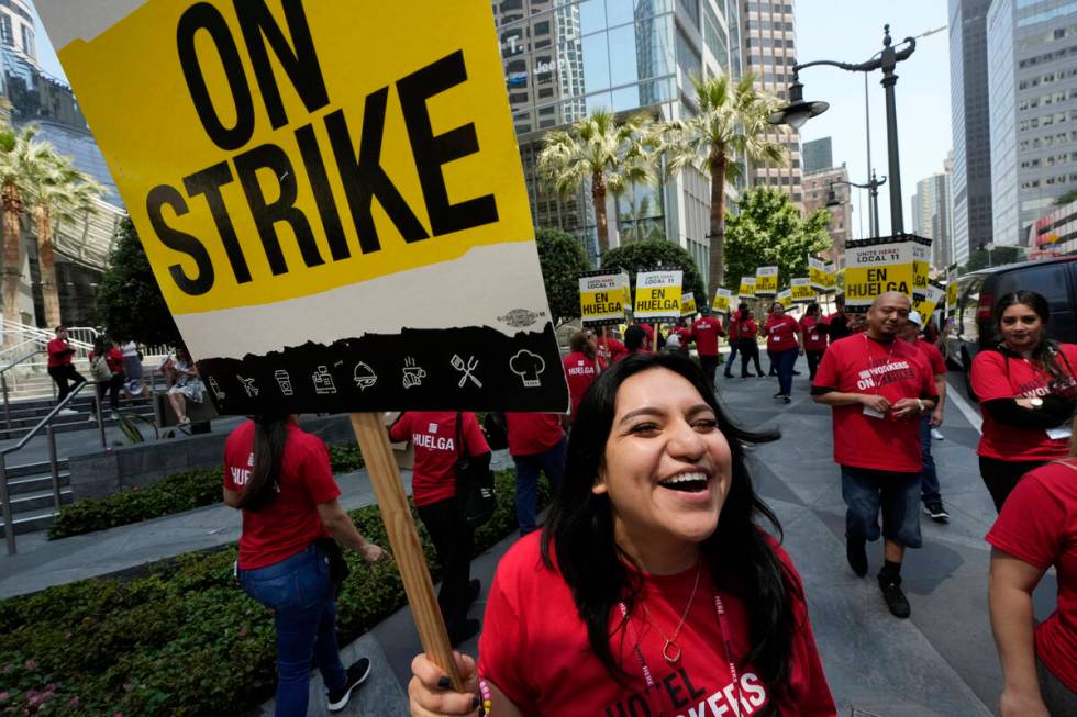 Striking hotel workers rally outside the Intercontinental Hotel after walking off their job ear ...