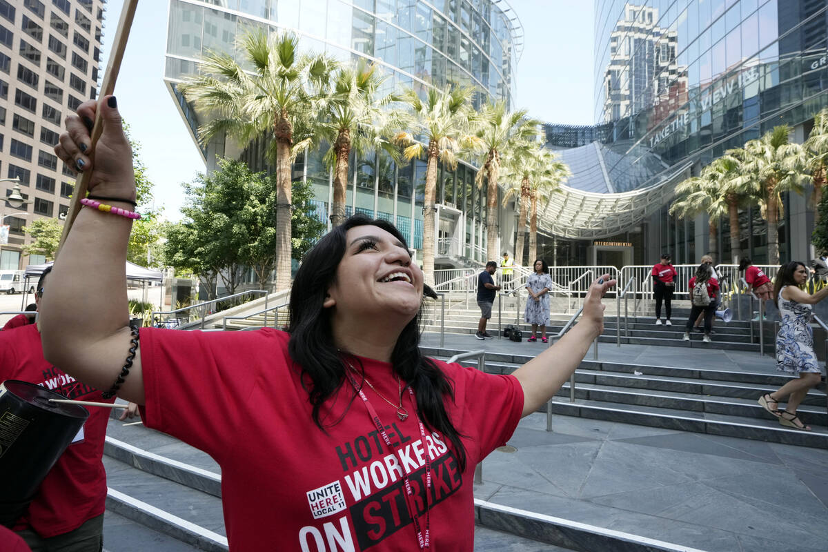 Striking hotel workers rally outside the Intercontinental Hotel after walking off their job ear ...