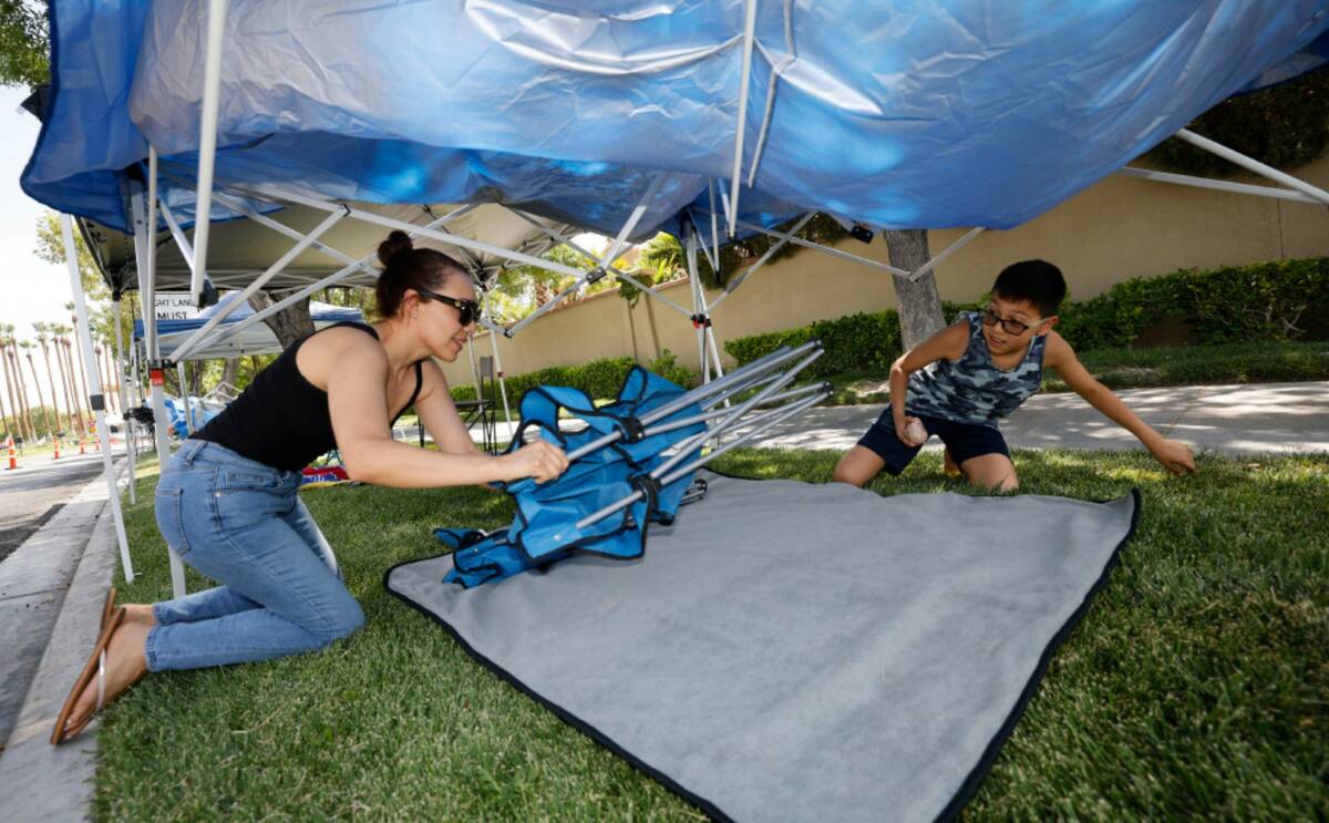 Elizabeth Guereque of Summerlin sets up a tent with her son Christian, 12, Monday, July 3, 2023 ...