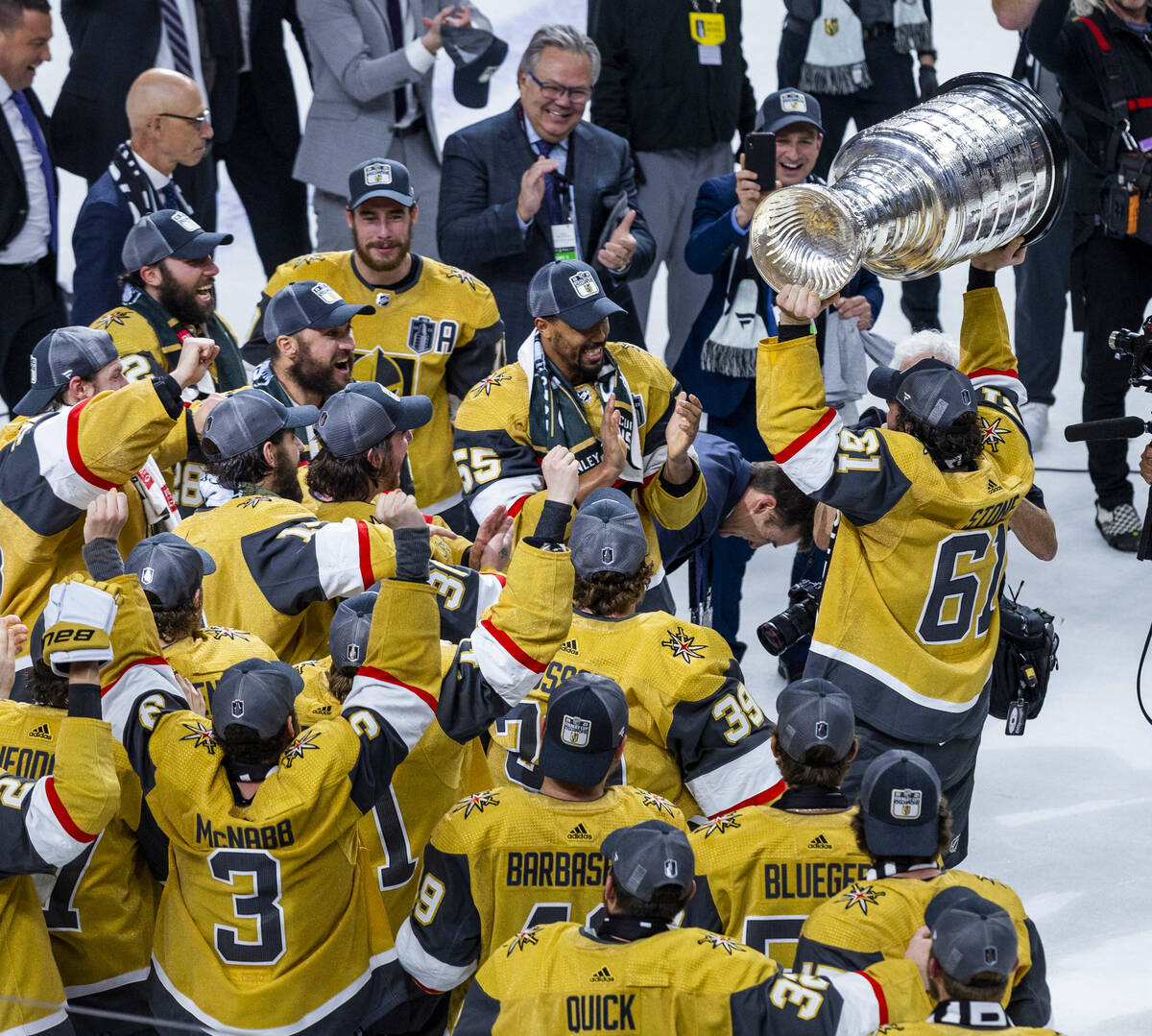 Golden Knights right wing Mark Stone (61) hoists the Stanley Cup before teammates defeating the ...