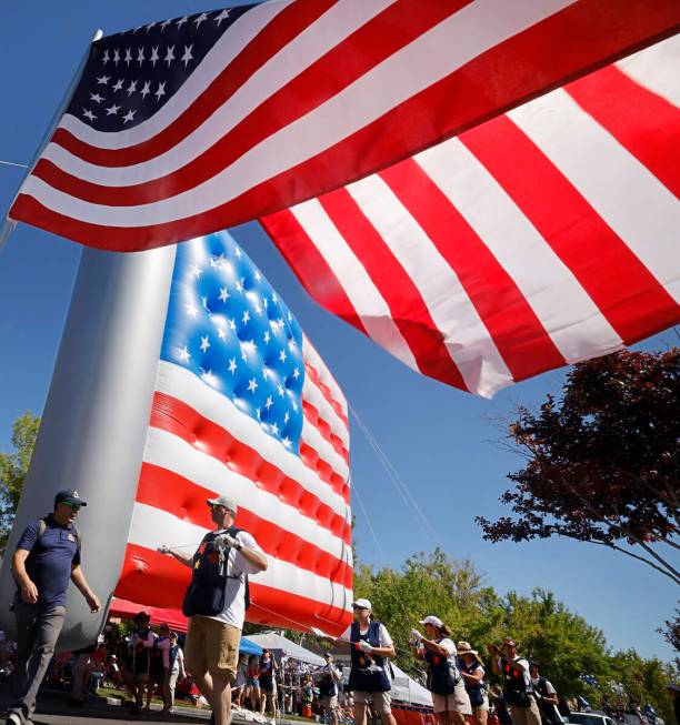 People carry a giant American flag inflatable balloon during the annual Summerlin Council Patri ...