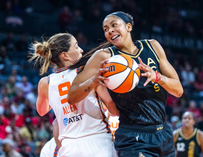 Las Vegas Aces forward Candace Parker (3) comes around the back of Connecticut Sun guard Rebecc ...