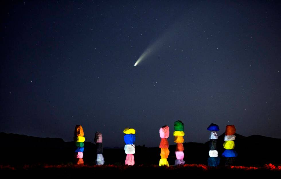 Comet NEOWISE streaks across the sky above the Seven Magic Mountains art installation on July 1 ...