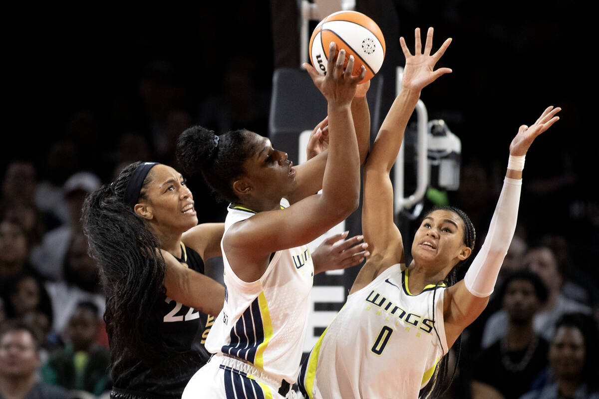 Las Vegas Aces forward A'ja Wilson (22) loses a rebound to Dallas Wings center Teaira McCowan, ...