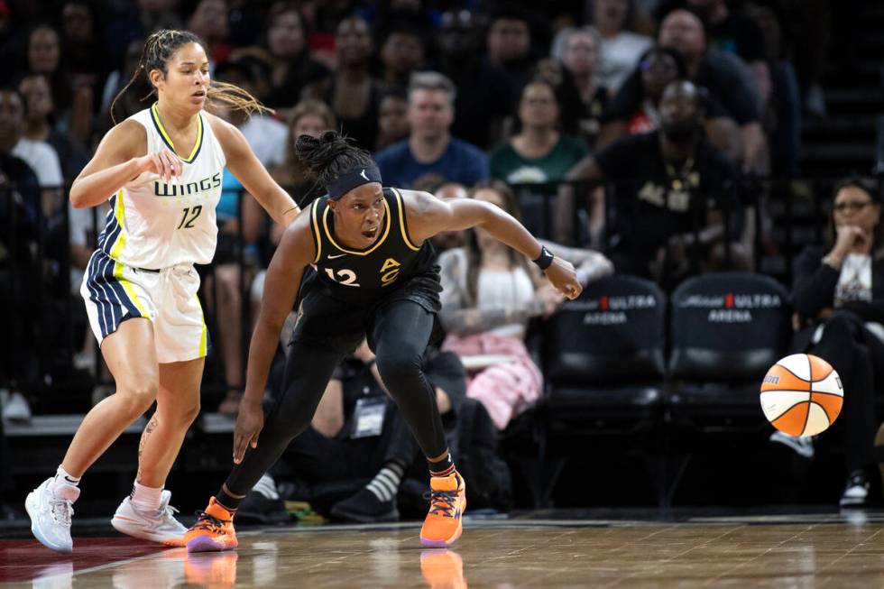 Las Vegas Aces guard Chelsea Gray (12) loses possession while Dallas Wings guard Veronica Burto ...