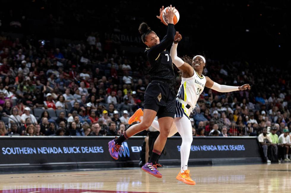 Las Vegas Aces forward Alysha Clark (7) jumps for the ball against Dallas Wings guard Arike Ogu ...