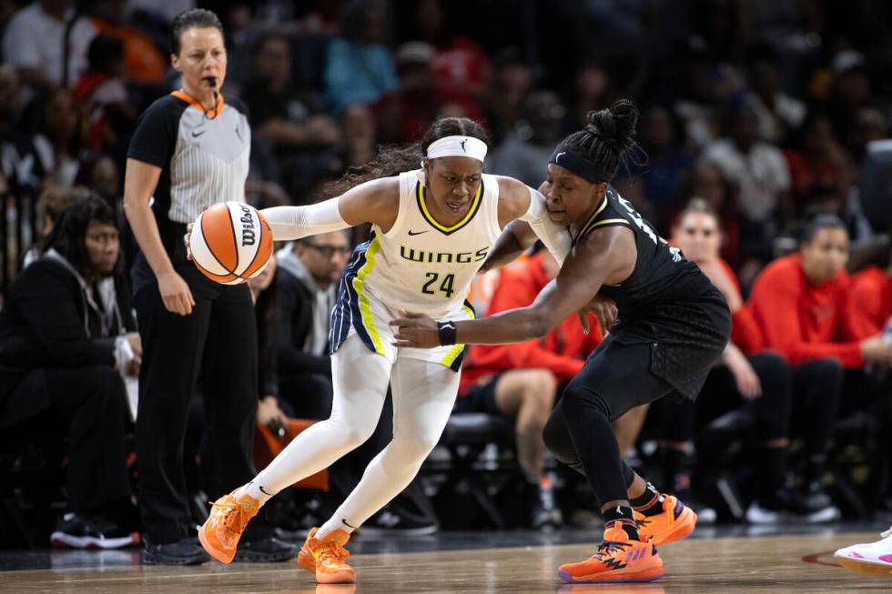 Dallas Wings guard Arike Ogunbowale (24) works around Las Vegas Aces guard Chelsea Gray, right, ...