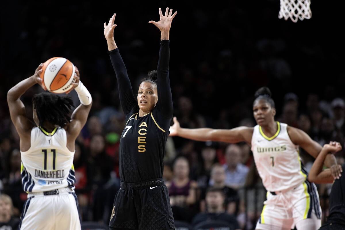 Las Vegas Aces forward Alysha Clark (7) guards Dallas Wings guard Crystal Dangerfield (11) duri ...