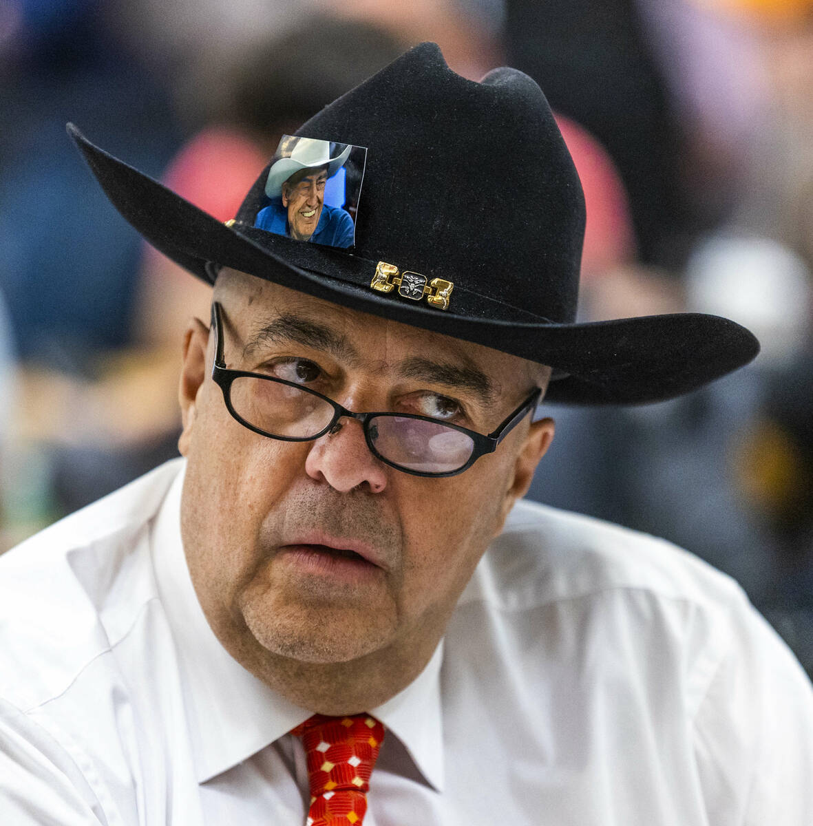A player has a photo of Doyle Brunson tucked in his hat during the final starting flight of Wor ...