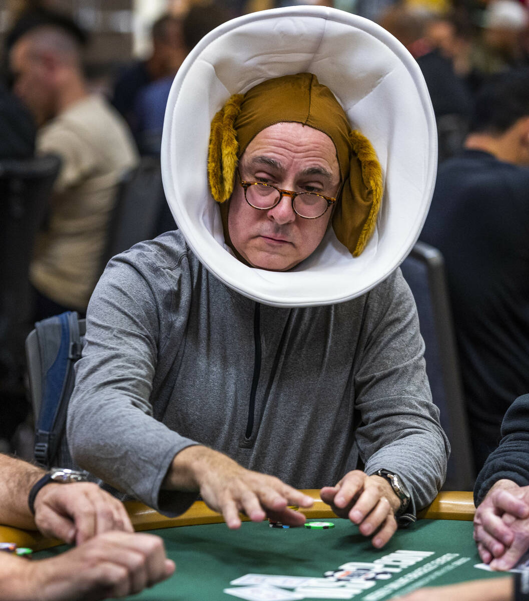 A player wears a dog cone and ears during the final starting flight of World Series of Poker $1 ...