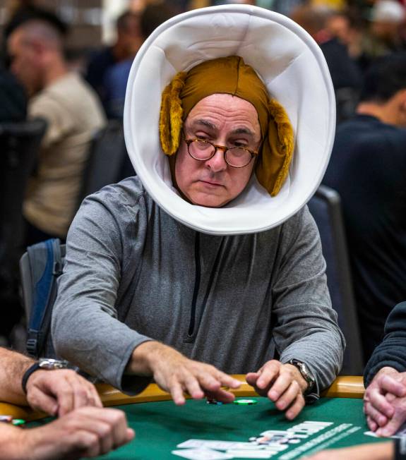 A player wears a dog cone and ears during the final starting flight of World Series of Poker $1 ...