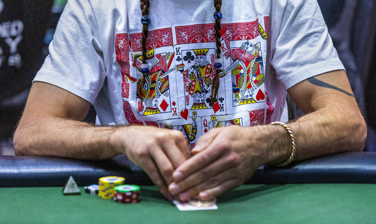 A player wears playing cards on his shirt during the final starting flight of World Series of P ...