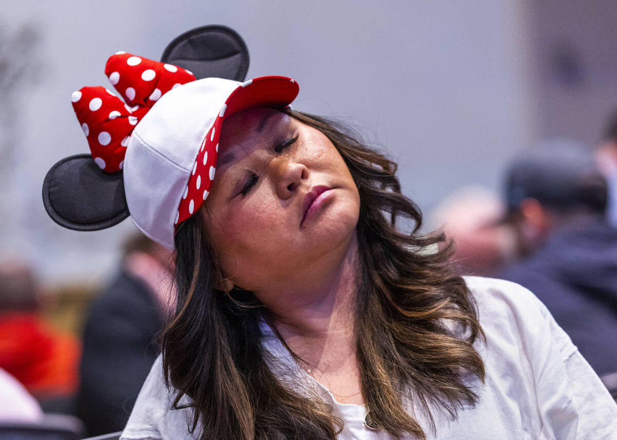 A player in Minnie Mouse hat rolls her neck during the final starting flight of World Series of ...