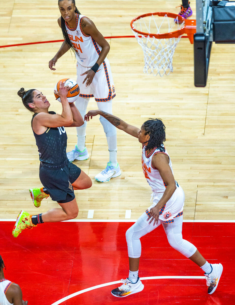 Las Vegas Aces guard Kelsey Plum (10) soars to the hoop past Connecticut Sun guard Tyasha Harri ...