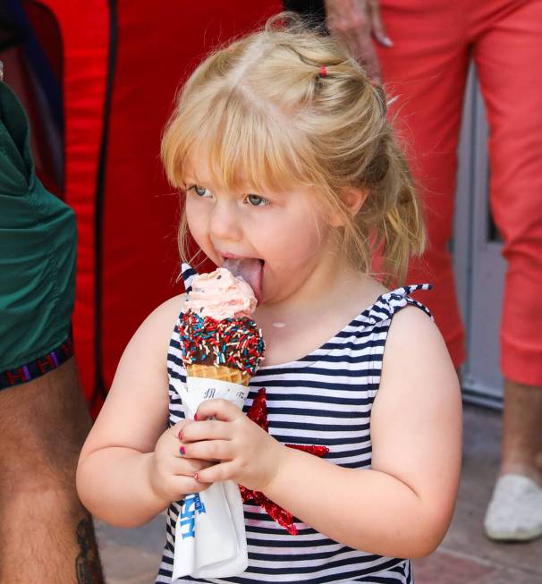 Charlotte King, 3, tries her first taste of Handel’s ice cream at the grand opening of L ...