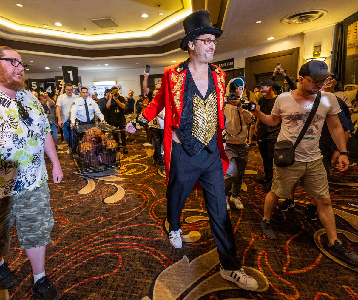 Phil Hellmuth as the “The Greatest Showman!" pulls a cage with Daniel "Junglem ...
