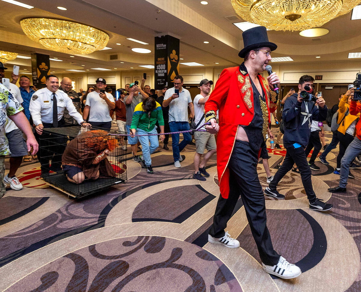 Phil Hellmuth as the “The Greatest Showman!" pulls a cage with Daniel "Junglem ...