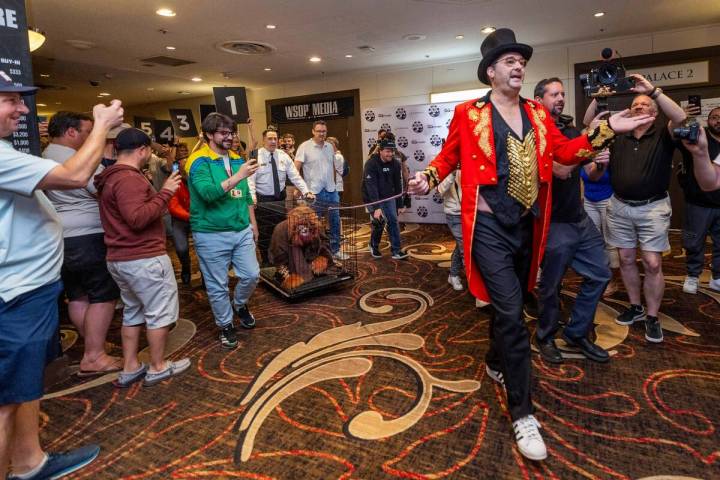 Phil Hellmuth as the “The Greatest Showman!" pulls a cage with Daniel "Jungleman" Cates for h ...