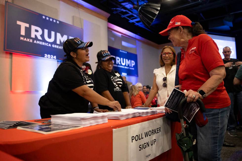 Volunteer Maria Altamirano, left, chats with Ella Burkestone about poll working before former P ...