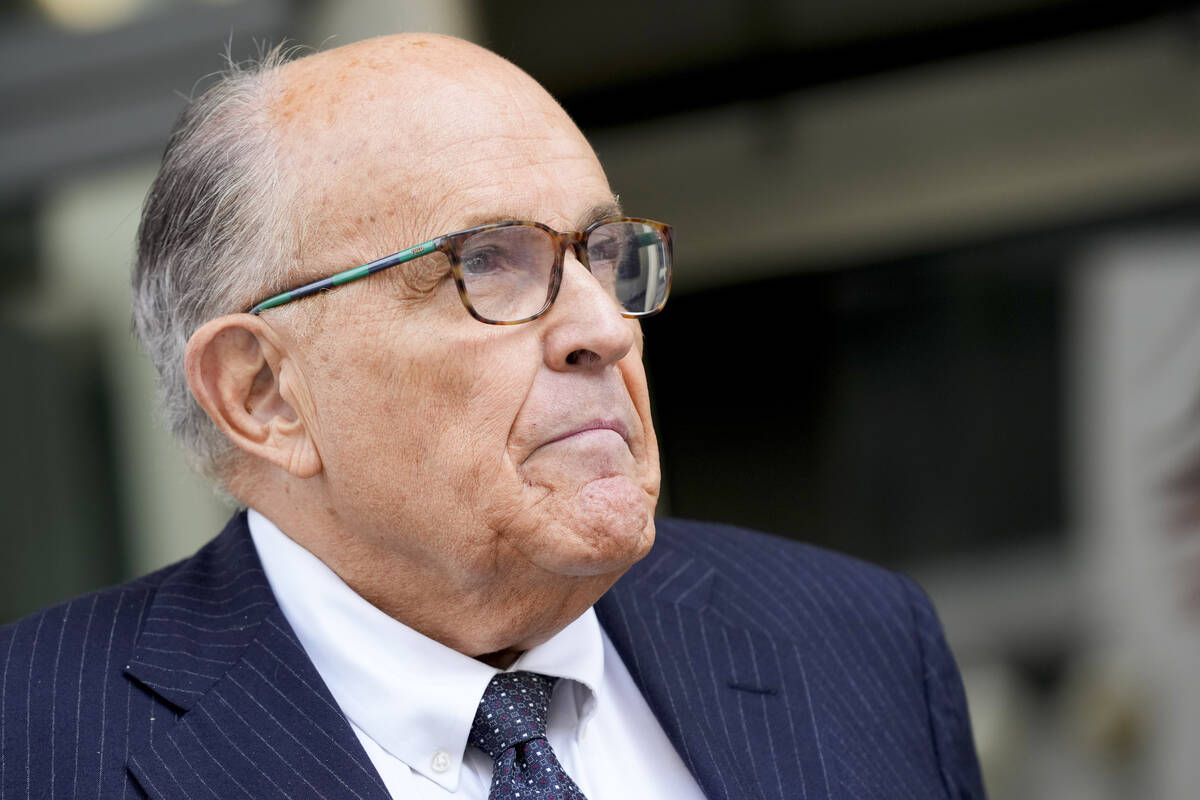 FILE - Rudy Giuliani speaks with reporters as he departs the federal courthouse, Friday, May 19 ...