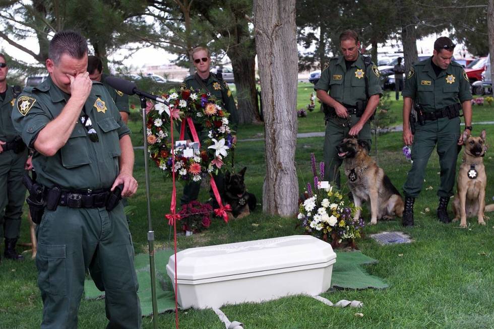 Las Vegas police K-9 officer Frank Sorrentino tears up over the casket of his partner Danny, du ...