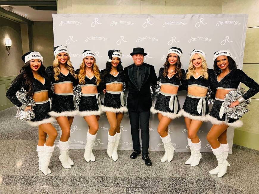 Raiders House Band founder David Perrico is shown with members of the Raiderettes dance team at ...