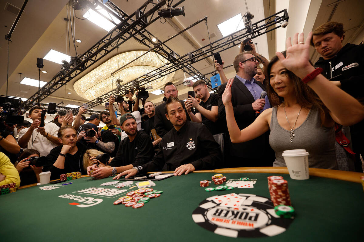 Yueqi Wang, right, reacts after she was eliminated during World Series of Poker $10,000 buy-in ...