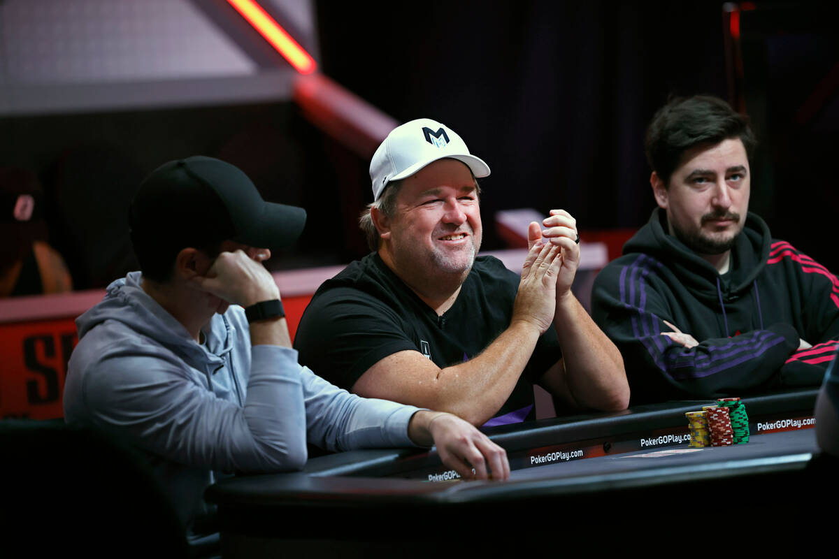 Chris Moneymaker, center, smiles as competing with Joshua Faris, left, and Alberto Cigliano, ri ...