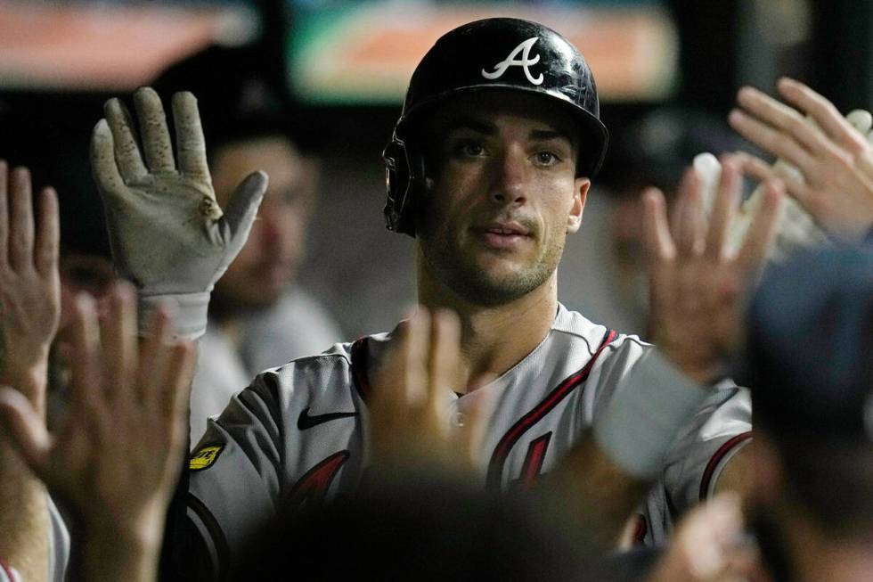 Atlanta Braves' Matt Olson gets high fives following his home run in the ninth inning of a base ...